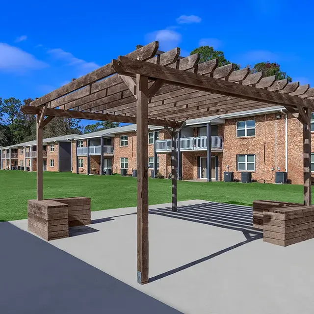 Prospect Heights A community patio with a pergola on a paved courtyard-style area surrounded by apartment buildings at Prospect Park.