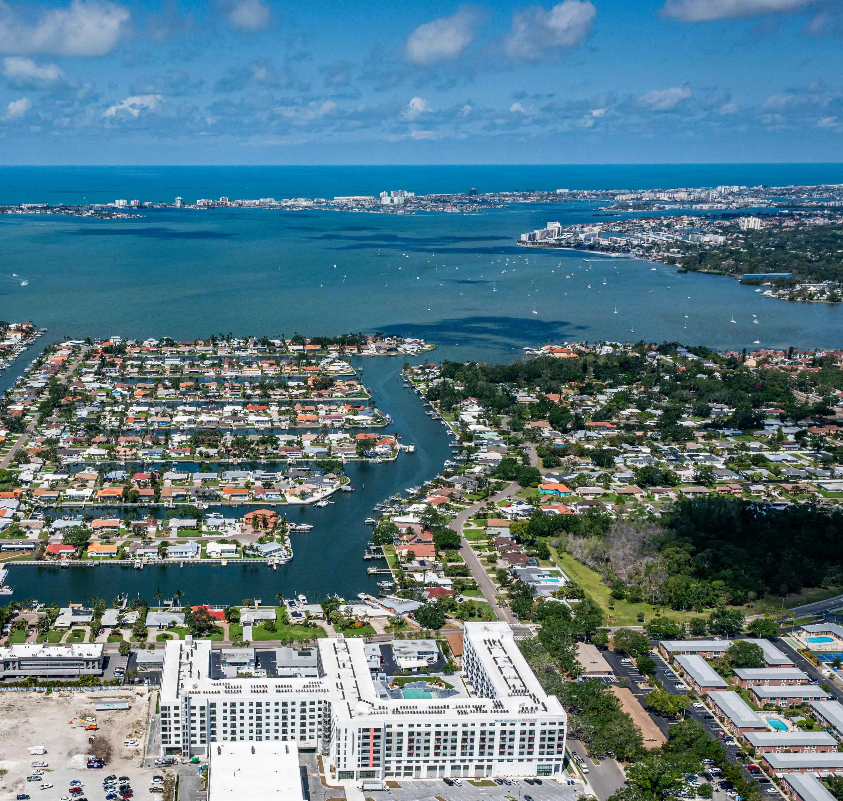 Aerial Coastal Neighborhoods Aerial view of a coastal area with residential neighborhoods alongside waterways and the ocean in the background.