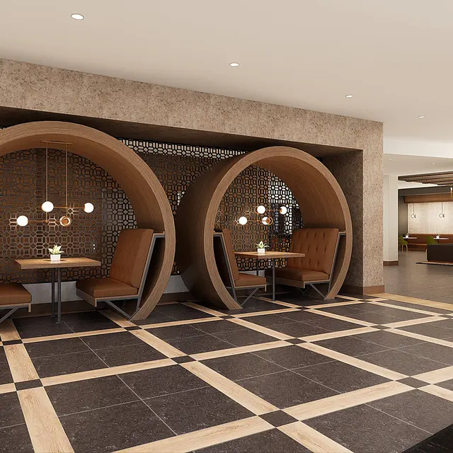 A modern lobby space featuring unique circular seating areas with wooden frames and pendant lighting. The floor is designed with large tiles arranged in a geometric pattern, and there's a small table in each seating nook. The background shows a minimalist reception area with shelves.