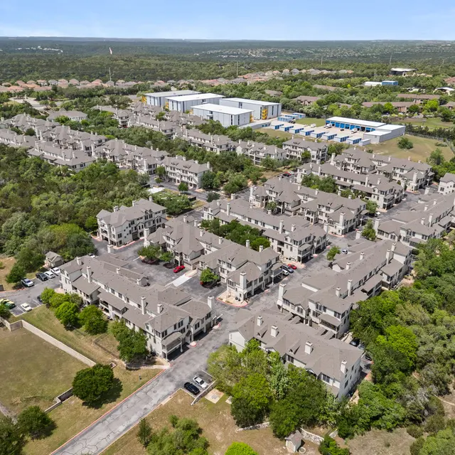 Aerial view of a suburban apartment complex surrounded by greenery