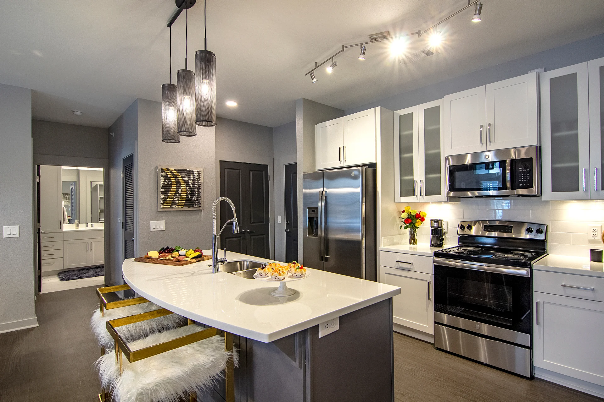 Photo of kitchen island and stainless-steel appliances in a two-bedroom apartment at The Pointe North Hills.