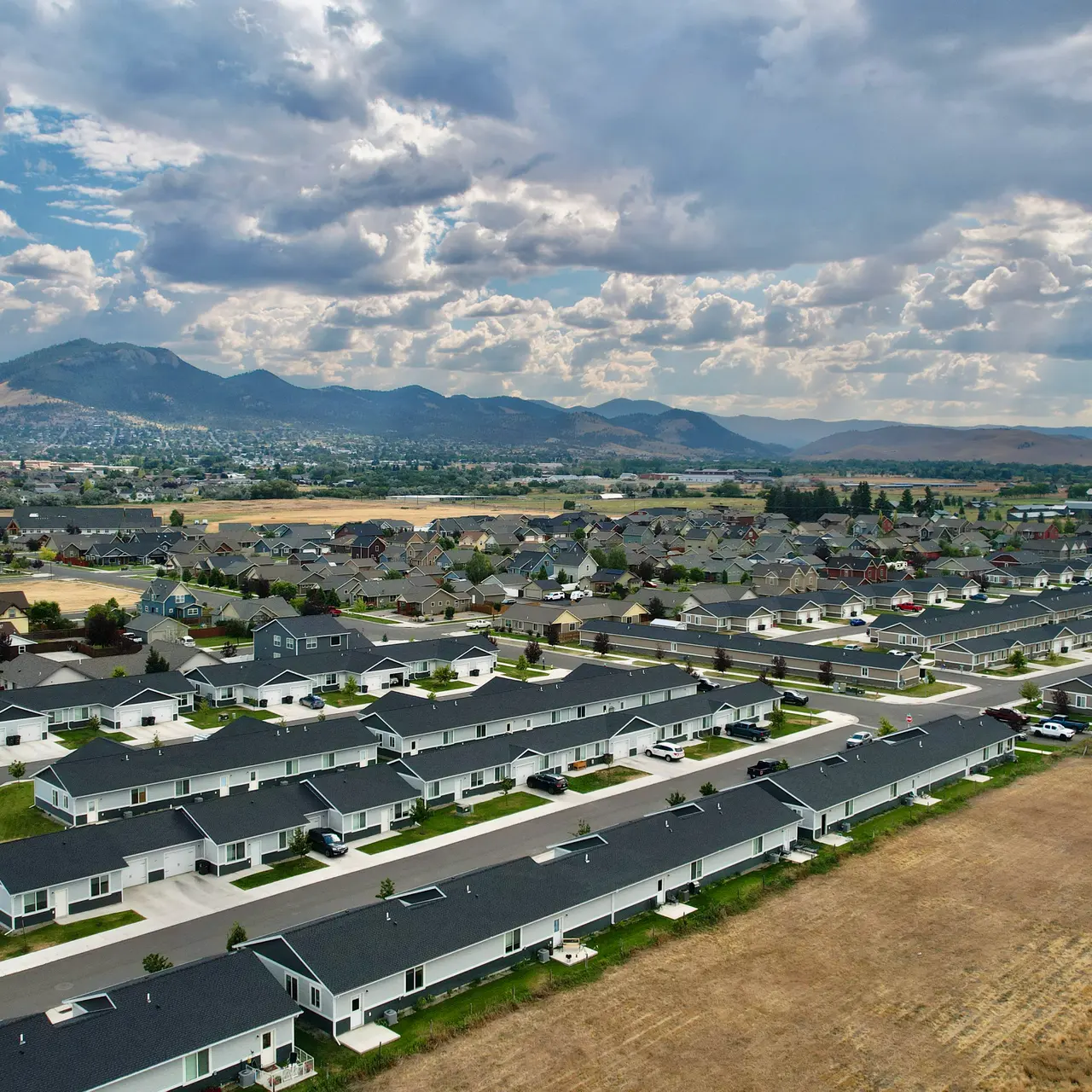 apartment aerial view Aerial view of Elkhorn Flats apartment complex in Helena, MT, showcasing its layout and surrounding environment, including mountains