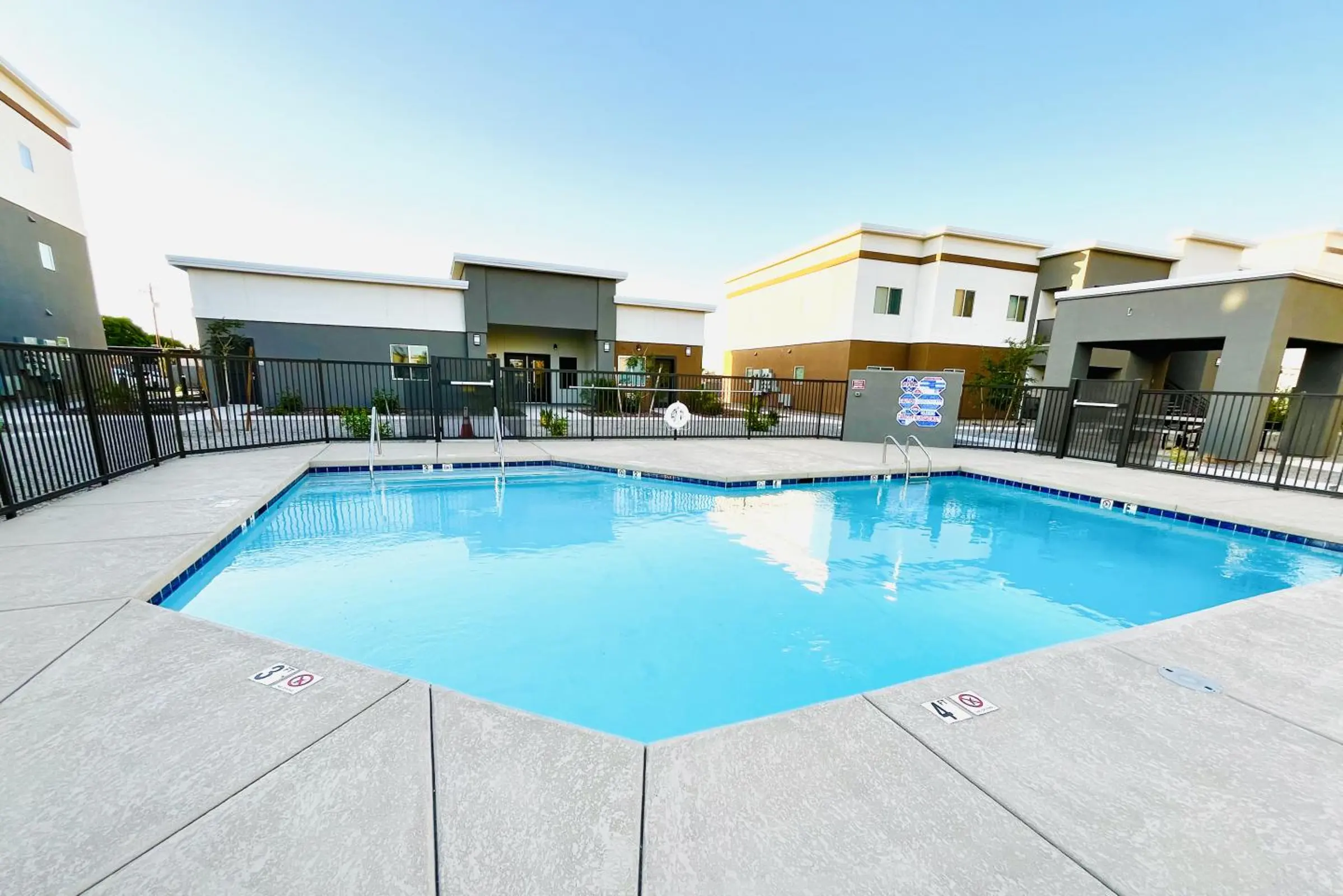 Wide pool view with reflections and entry rails.