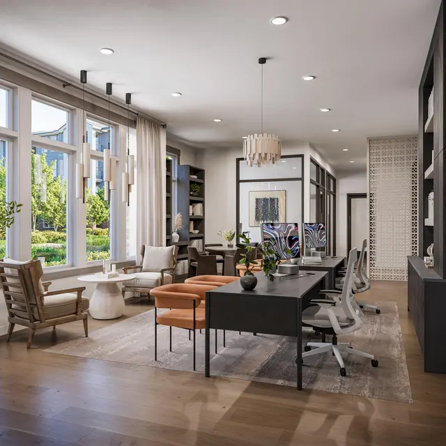 A modern office space with large windows, bright natural light, a long table surrounded by chairs, and stylish decor including planters and artwork.