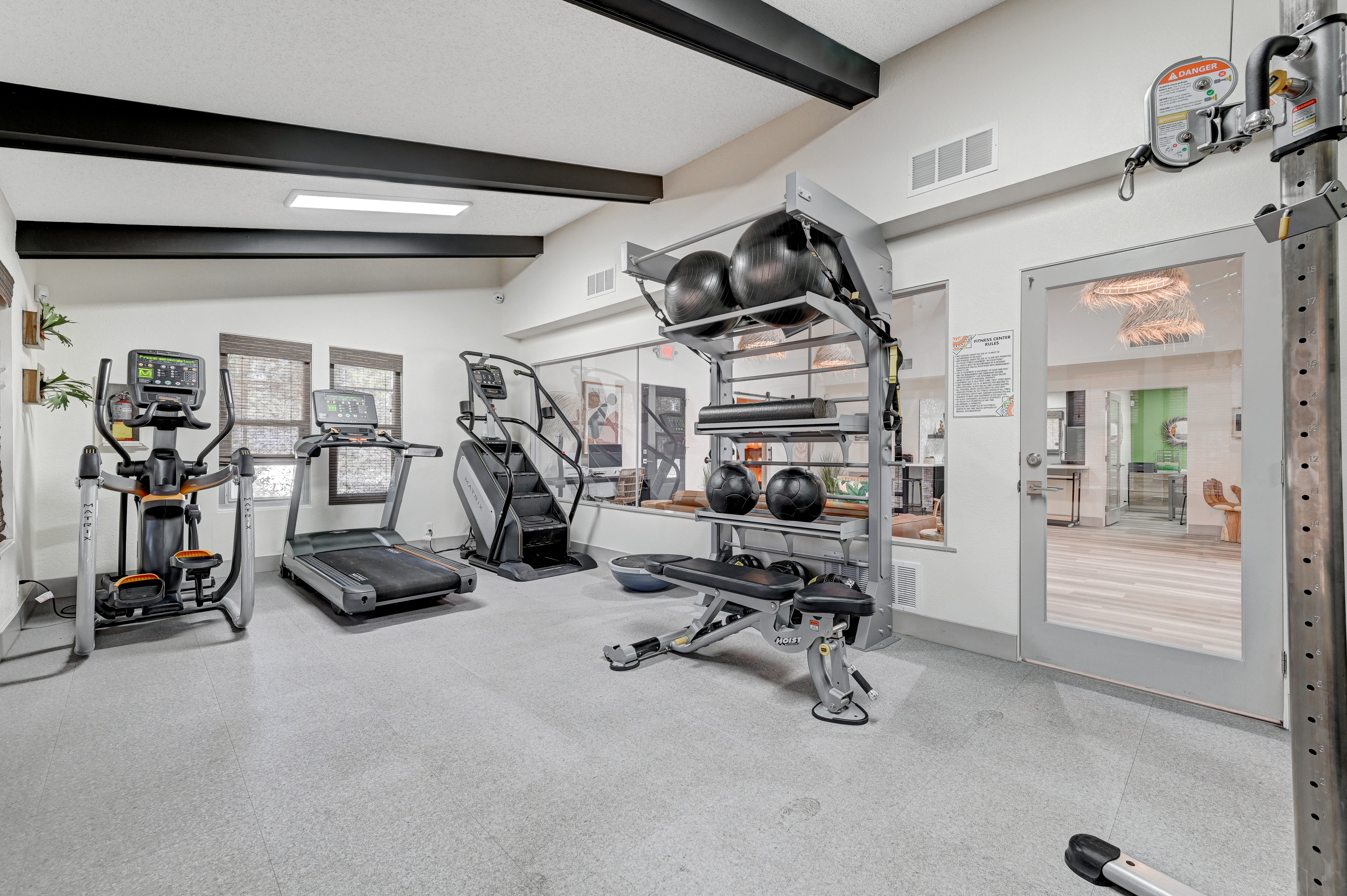 A well-equipped gym area featuring various exercise machines and weights.