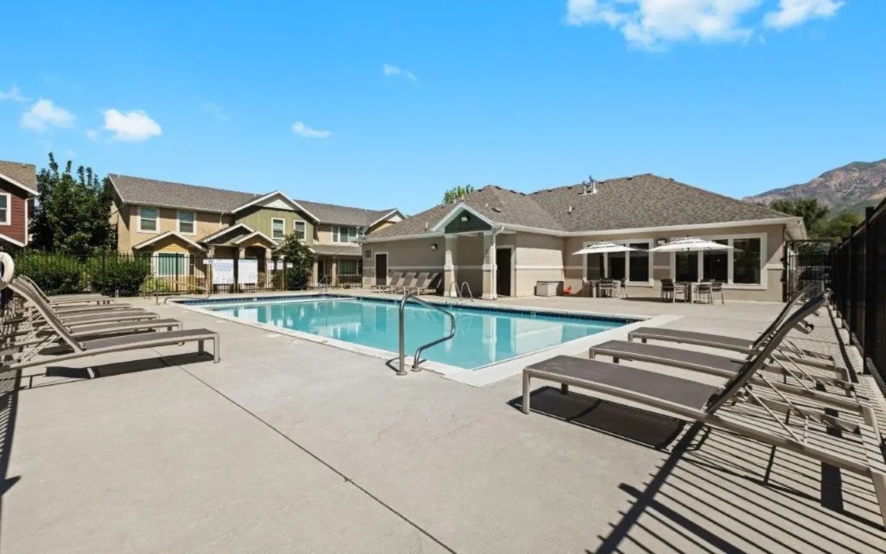Swimming Pool Area View of a swimming pool area with lounge chairs and buildings in the background
