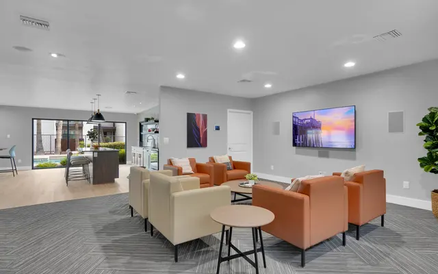 Modern lounge area with seating and a television on the wall