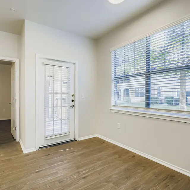 Interior view of a modern apartment with wooden flooring and large windows