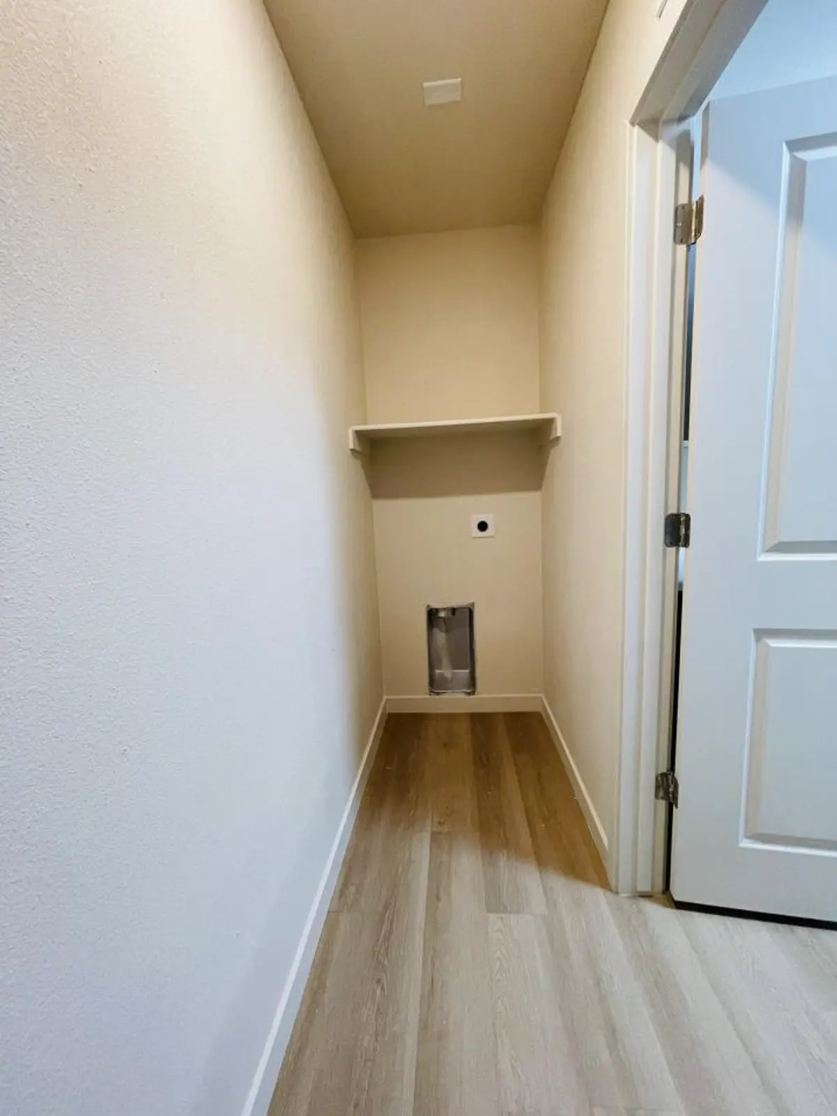 Laundry utility alcove with visible hookups and vent; no machines.