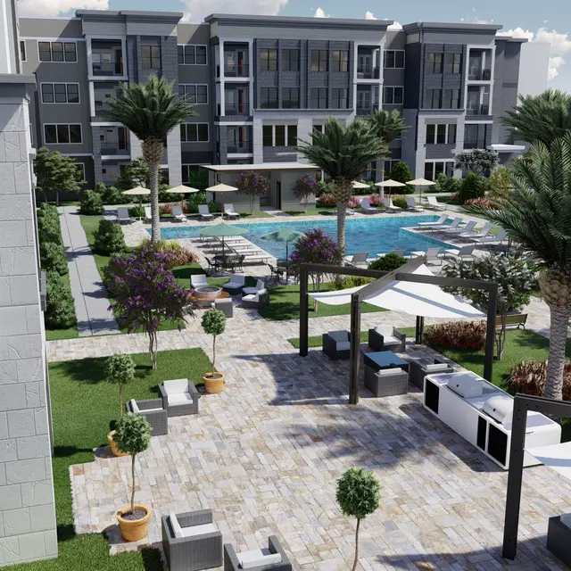 A modern apartment complex outdoors featuring a pool area surrounded by lounge chairs, palm trees, and landscaped gardens.