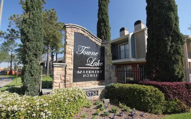 Towne Lake Apartment Homes Entrance Sign for Towne Lake Apartment Homes surrounded by greenery and flowers