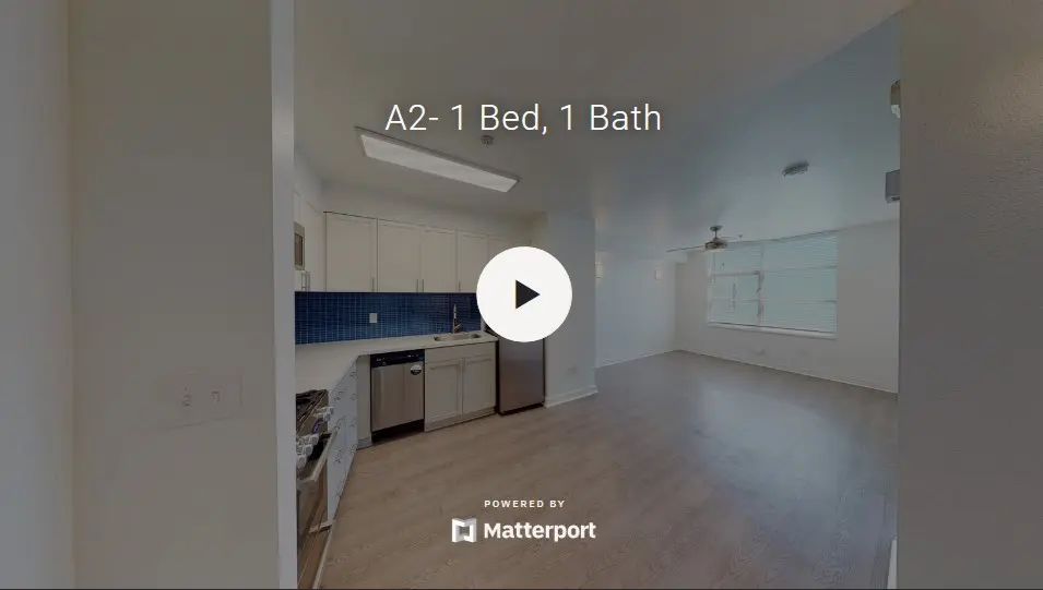 Interior view of a 1 bed, 1 bath apartment showcasing a kitchen area and living space.