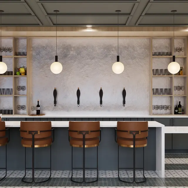 A modern kitchen bar area featuring a sleek counter with several high chairs, contemporary lighting fixtures, and a stylish backdrop with shelves.