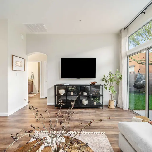 Bright living room with ceiling fan and natural light at Avilla Marana detached rental homes