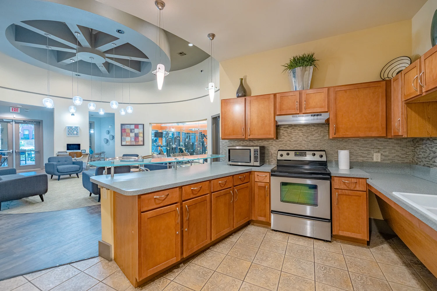 Modern Kitchen and Living Area A modern kitchen with wooden cabinets, stainless steel appliances, and a spacious living area in the background.