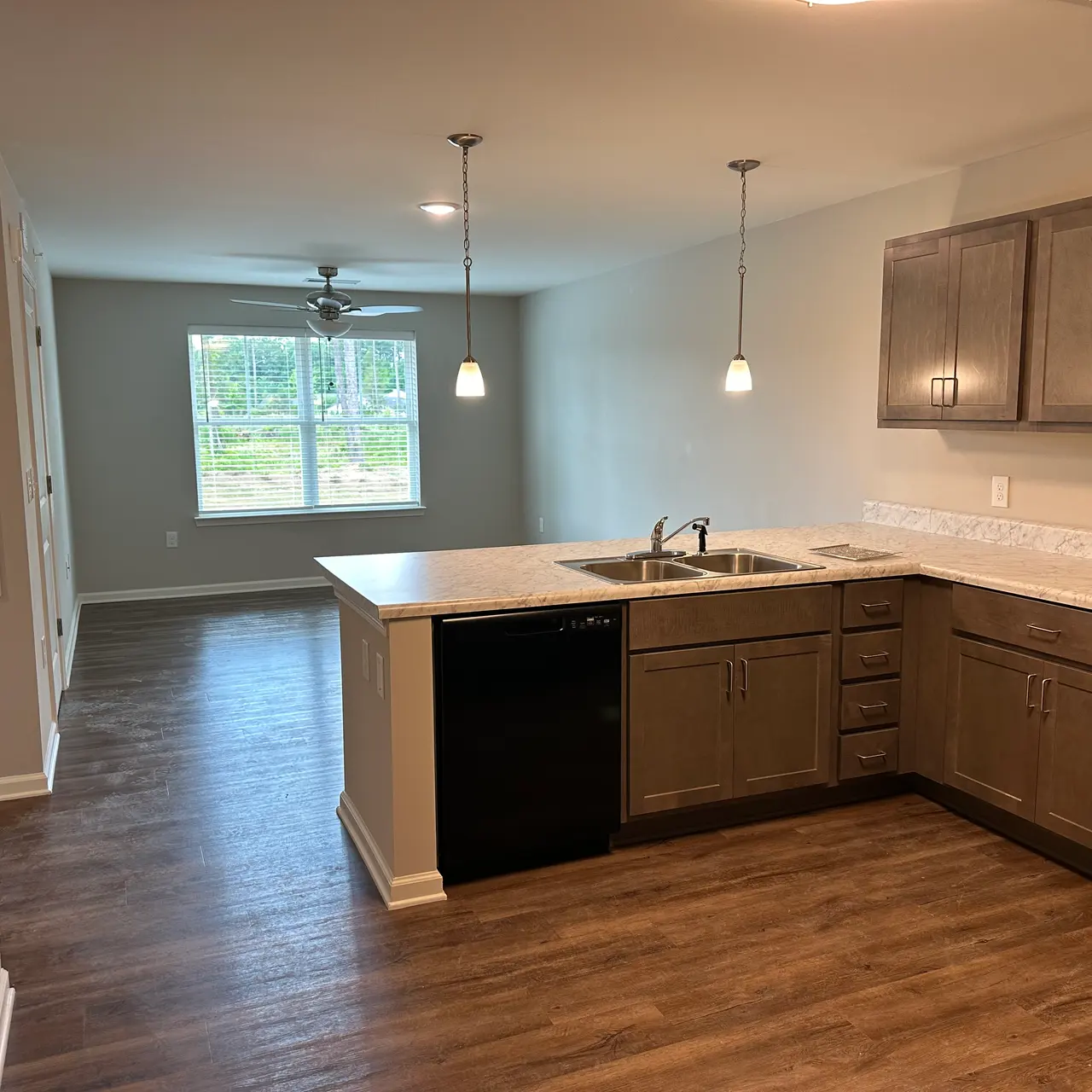 A contemporary kitchen seamlessly integrated with the living area, featuring sleek cabinets and a cozy ambiance.