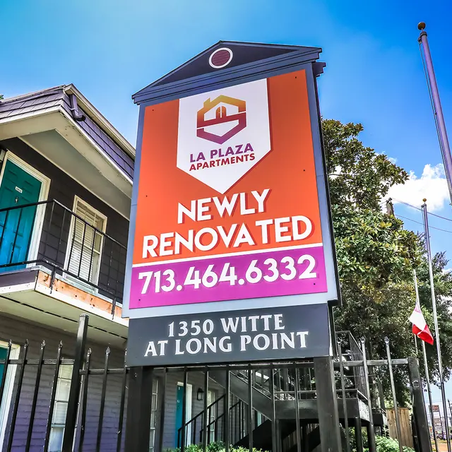La Plaza Apartments Renovation Announcement Sign for La Plaza Apartments indicating they are newly renovated, with contact number and address displayed