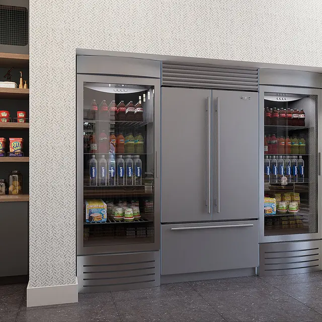 A modern kitchen featuring a large refrigerator with glass doors and organize shelves filled with various food items.