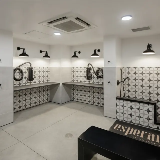 An interior view of a modern bathroom with stylish decor featuring patterned tiles and contemporary fixtures.