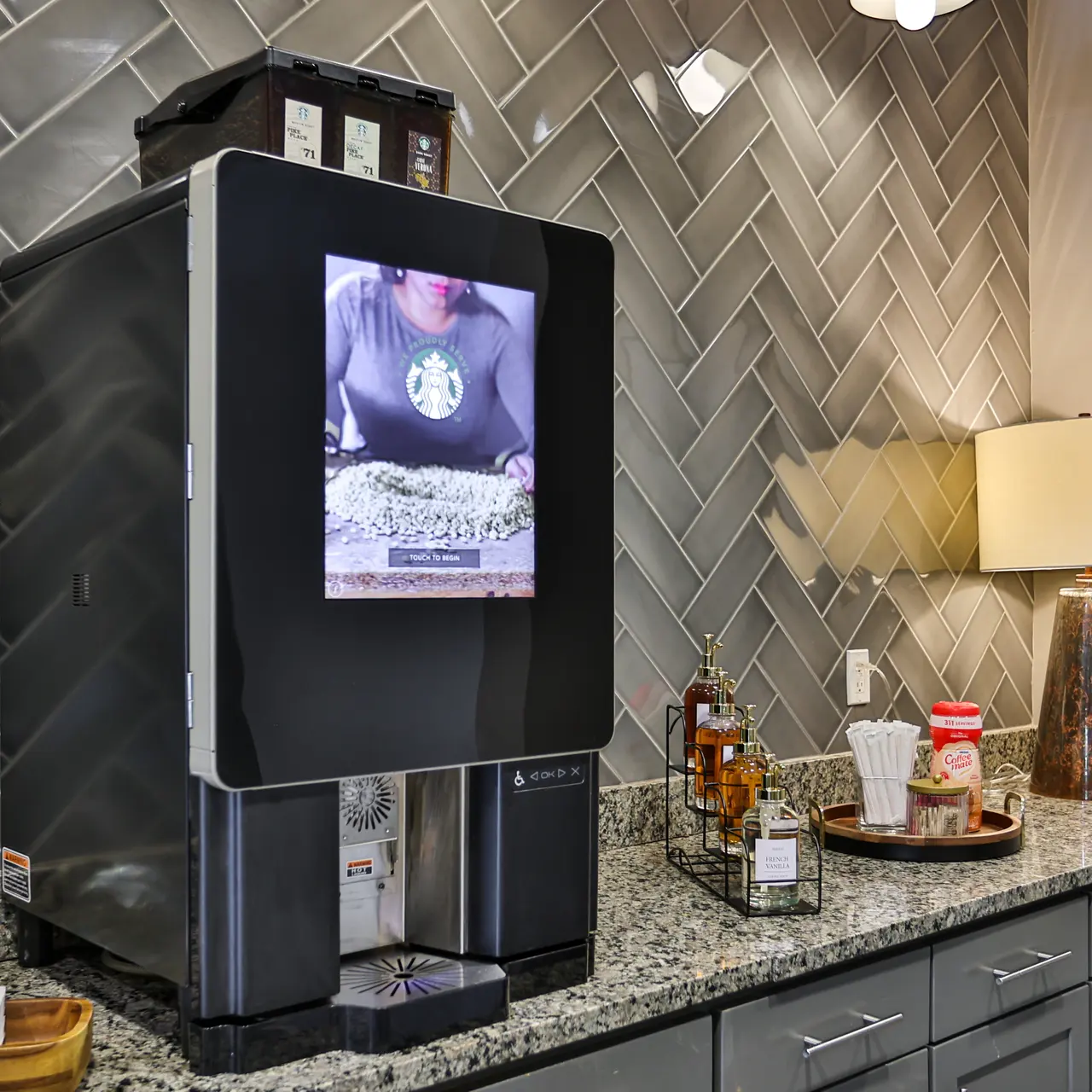 Modern Coffee Machine with Digital Display A stylish coffee machine with a digital screen, displaying a brewing process, on a granite countertop in a modern kitchen.
