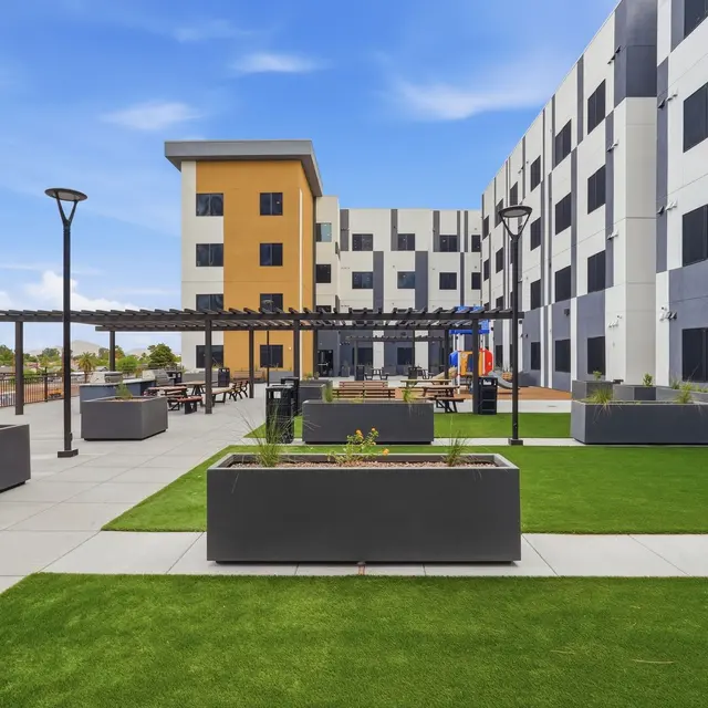 Modern Outdoor Space with Landscaping A modern outdoor area with landscaping and seating near a building.