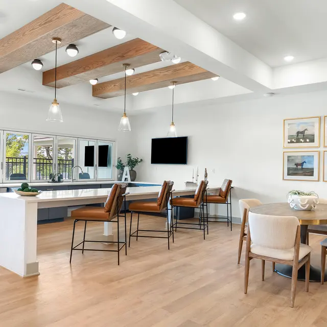 Bright, modern dining area with a large table and high-top bar seating