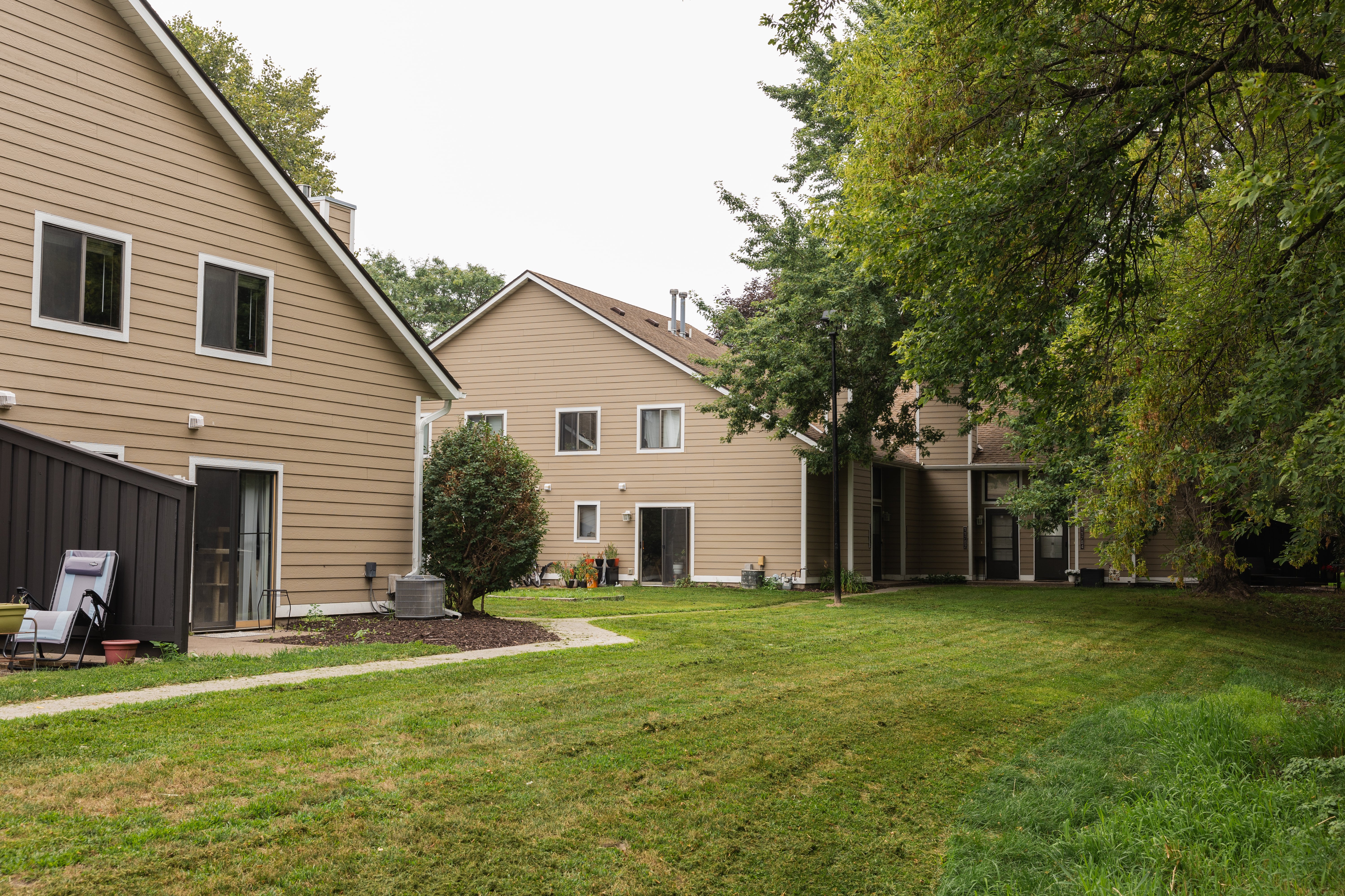 Residential Unit Exterior Landscape Exterior view of residential buildings surrounded by grass and trees.