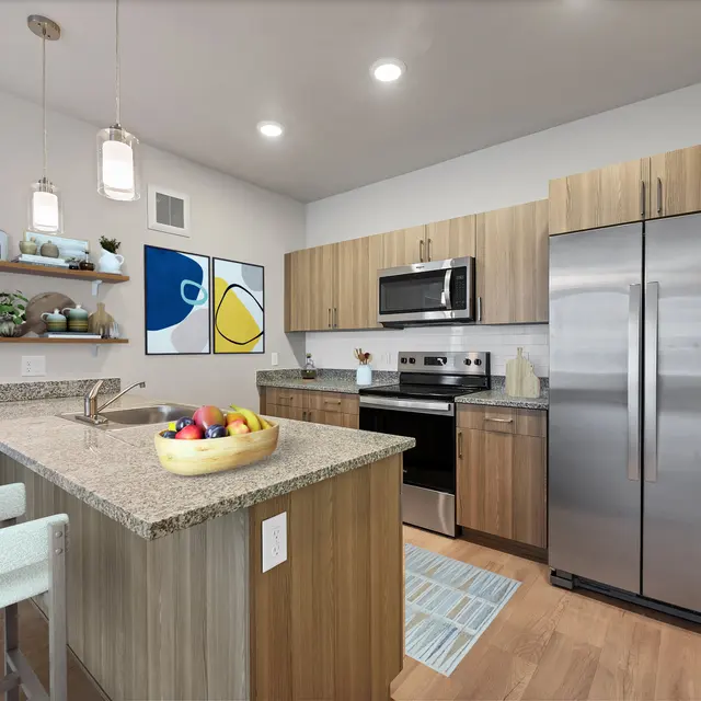 Modern Kitchen Interior A modern kitchen featuring wooden cabinets, stainless steel appliances, and an island with bar stools. Decor items and wall art enhance the space.