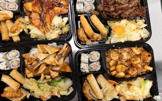 Quickway A variety of food platters featuring sushi, spring rolls, grilled fish, beef, and shrimp dishes with vegetables.