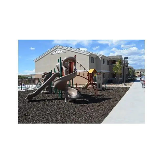 A playground with slides and climbing structures on a sunny day.