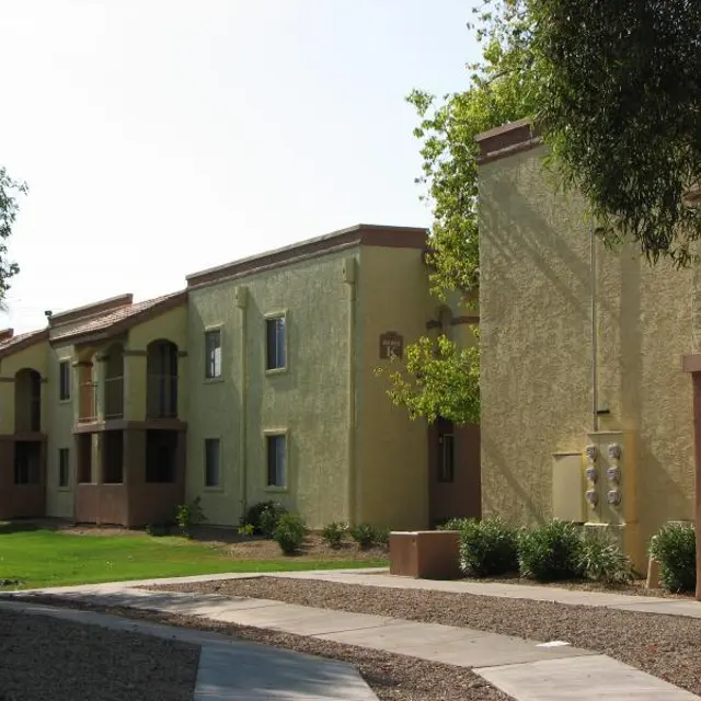 Residential Apartment Complex View of a residential apartment complex with two-story buildings, green landscaping, and pathways.