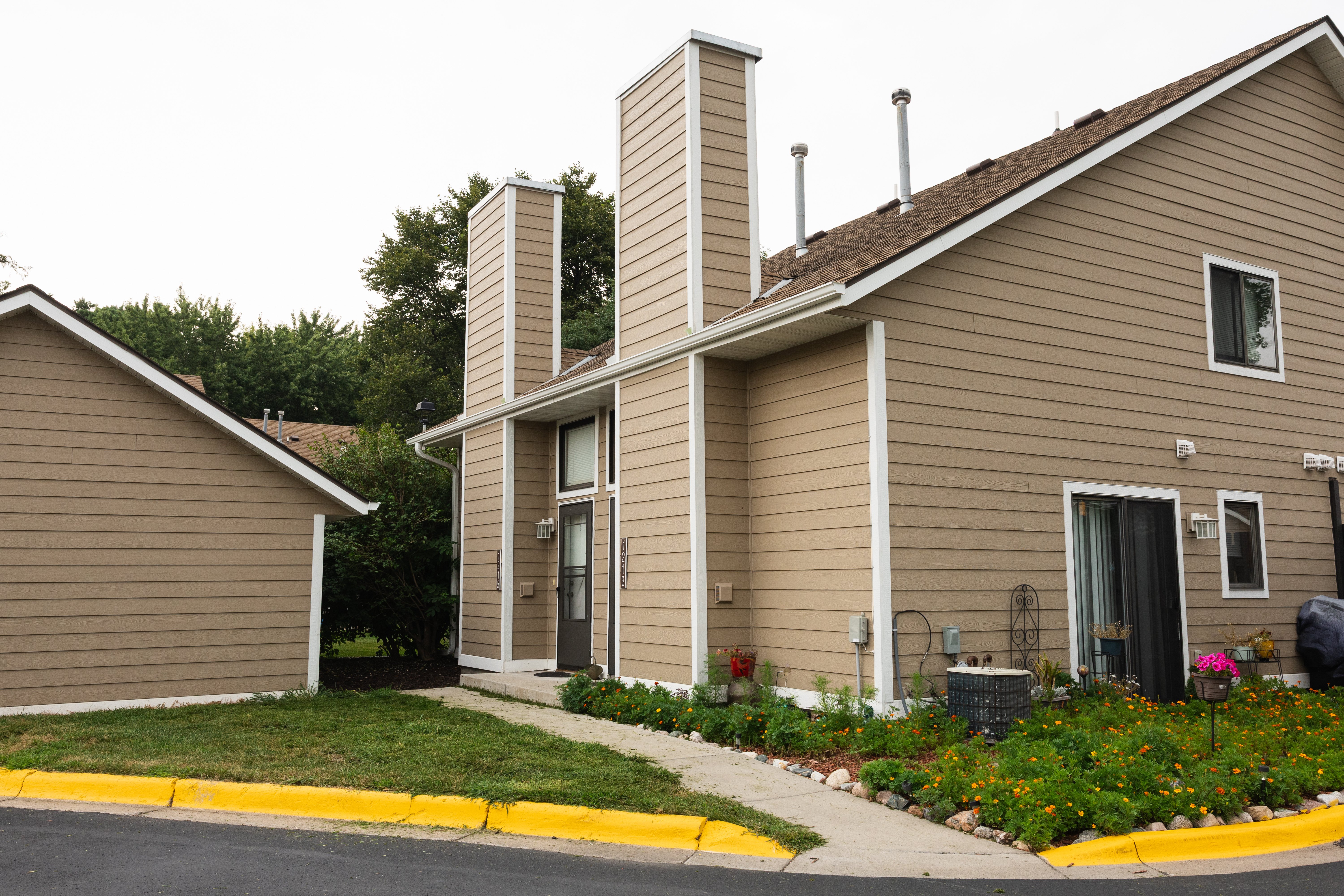 Modern Residential Building Exterior view of a two-story residential building with modern architecture and landscaping.