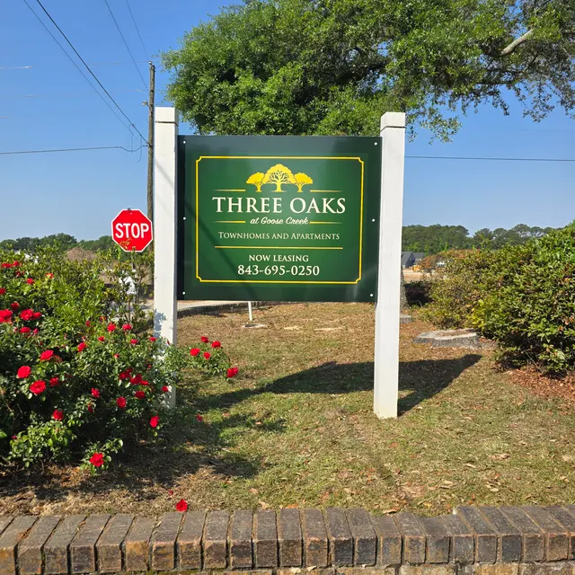 Three Oaks Townhomes and Apartments Sign Sign for Three Oaks Townhomes and Apartments with a telephone number for leasing inquiries.