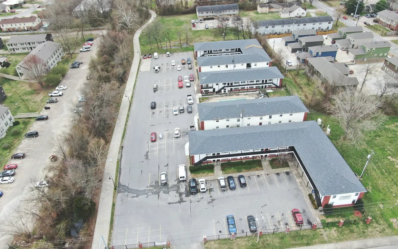 Aerial View of Apartment Complex Aerial view of an apartment complex with parking lot and surrounding buildings.