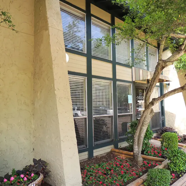 Scenic Building Exterior Exterior view of a building with large windows and landscaped greenery.