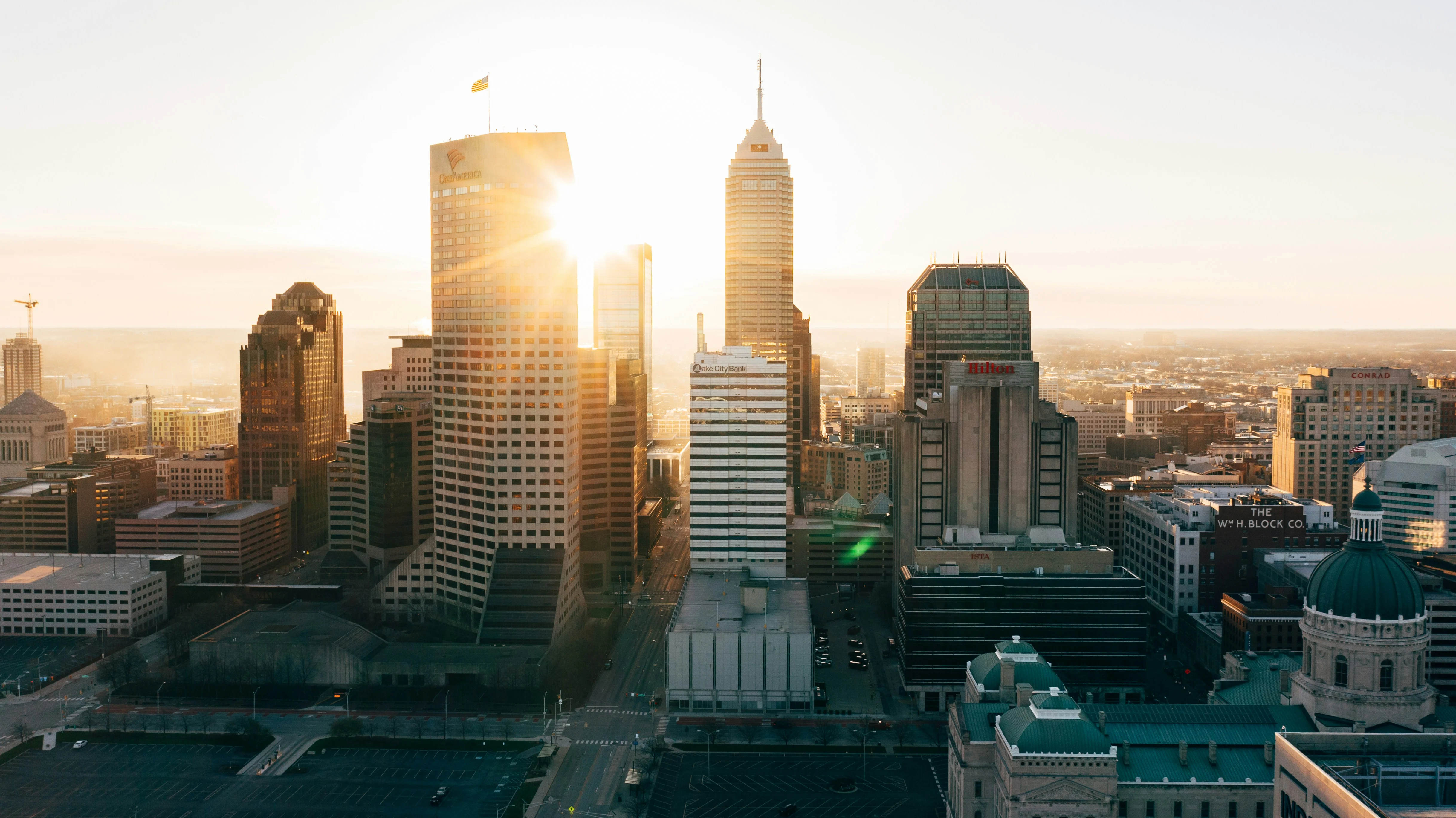 Indianapolis Skyline at Sunset Aerial view of a city skyline at sunset with tall buildings and a clear sky.