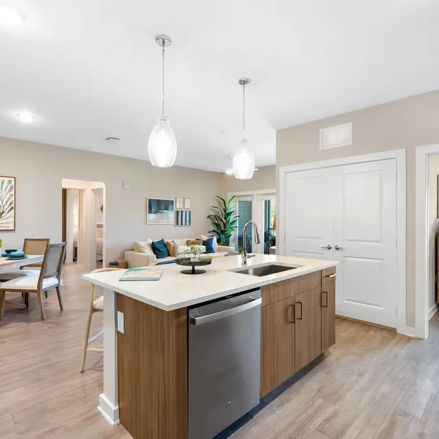 Contemporary Kitchen and Dining Room A contemporary kitchen and dining area with wooden flooring, featuring a kitchen island, a dining table, and modern appliances.