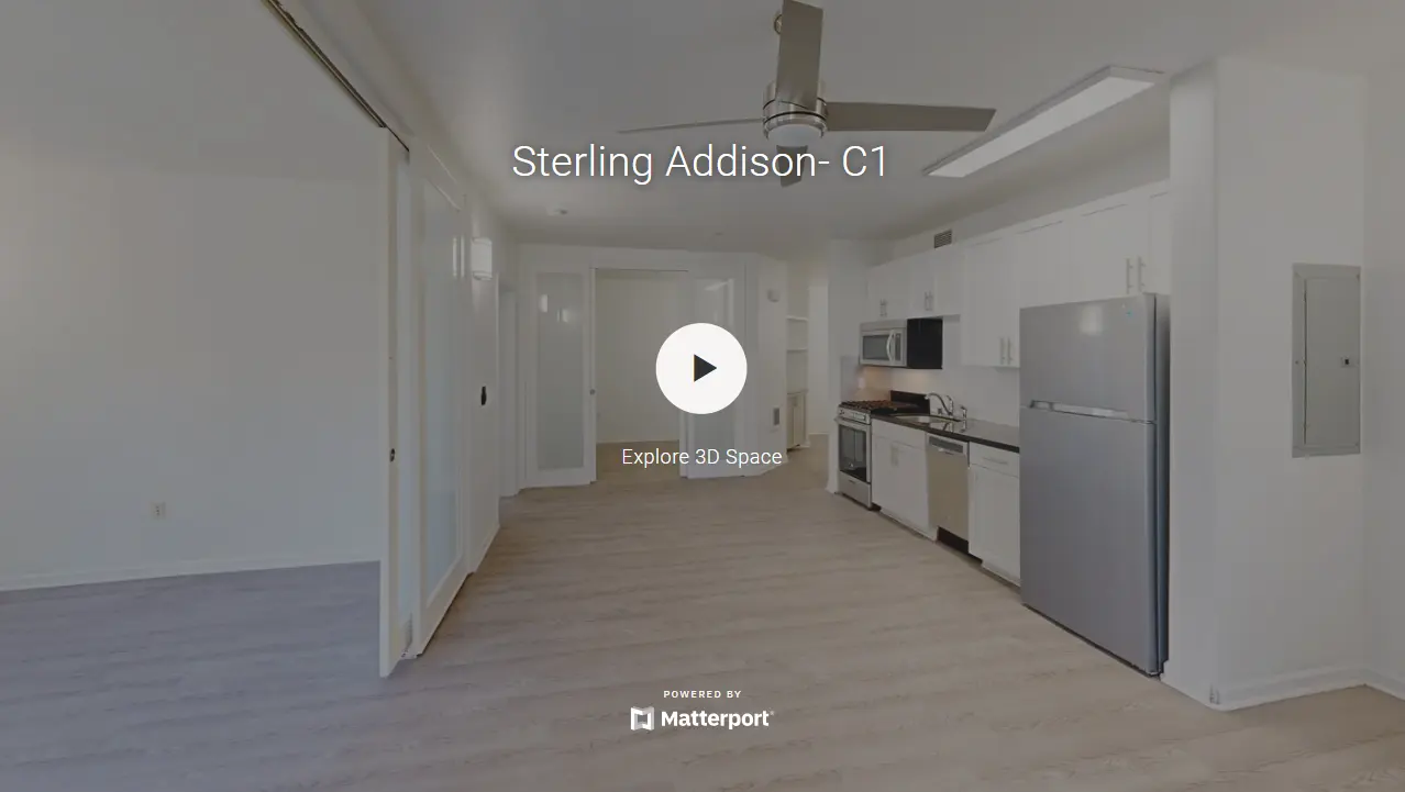 A spacious living area featuring a modern kitchen with white cabinets, stainless steel appliances, and light wood flooring.