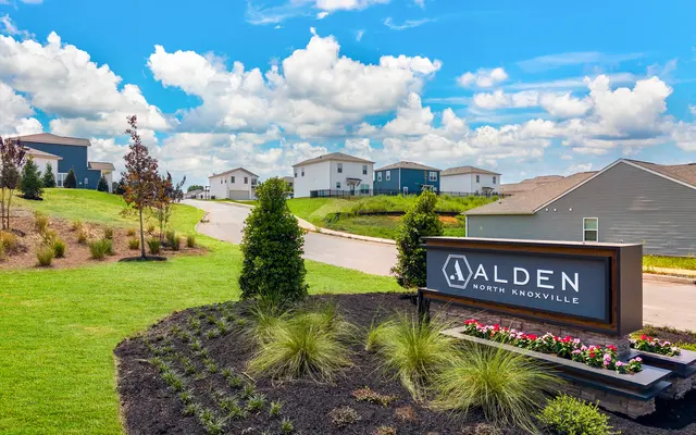 Entrance sign for Alden North Knoxville with landscaping and homes in the background.