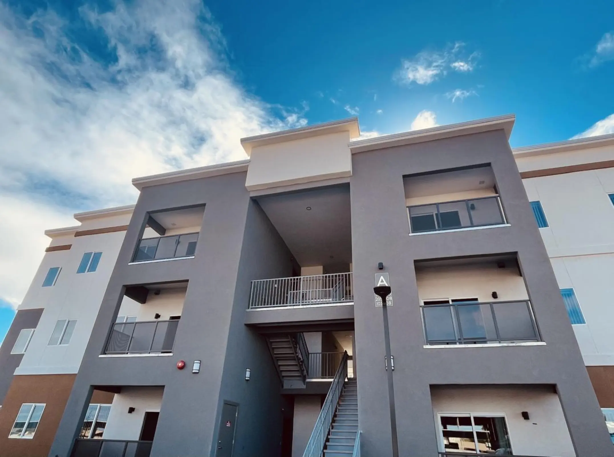 Building front with stairs and balconies.