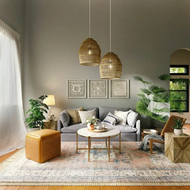 A cozy modern living room featuring a grey sofa, light wooden flooring, a round coffee table, and stylish hanging lamps. Decorative plants and artwork adorn the space, creating a warm atmosphere.