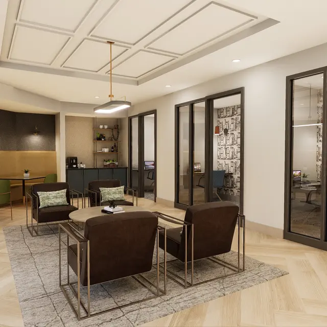 A modern office interior featuring a seating area with brown chairs and a light-colored rug, surrounded by glass-walled meeting rooms and stylish decor.