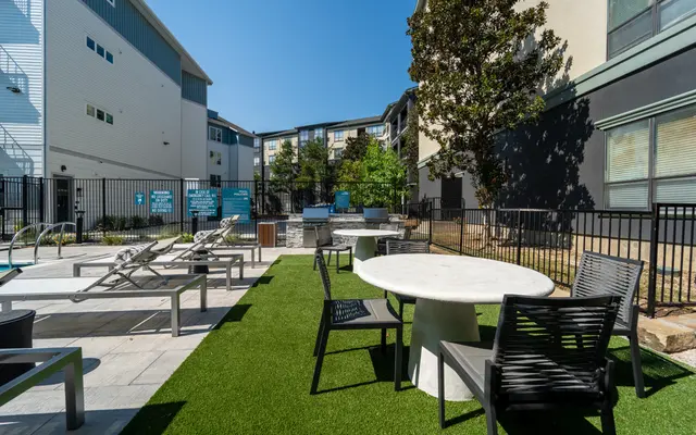 A modern outdoor pool area featuring lounge chairs
