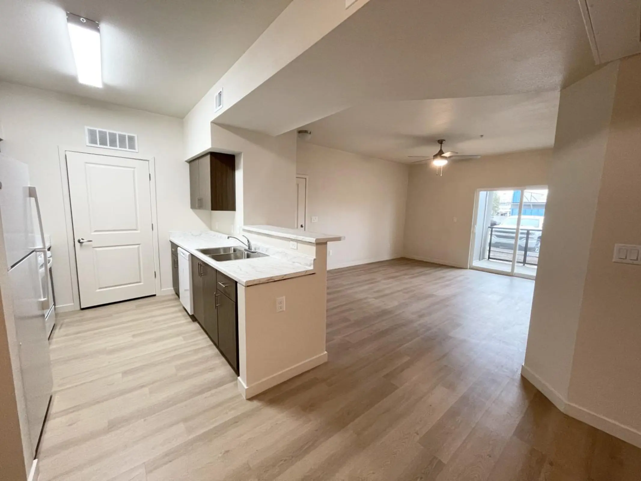 Kitchen breakfast counter beside living room and sliding door.