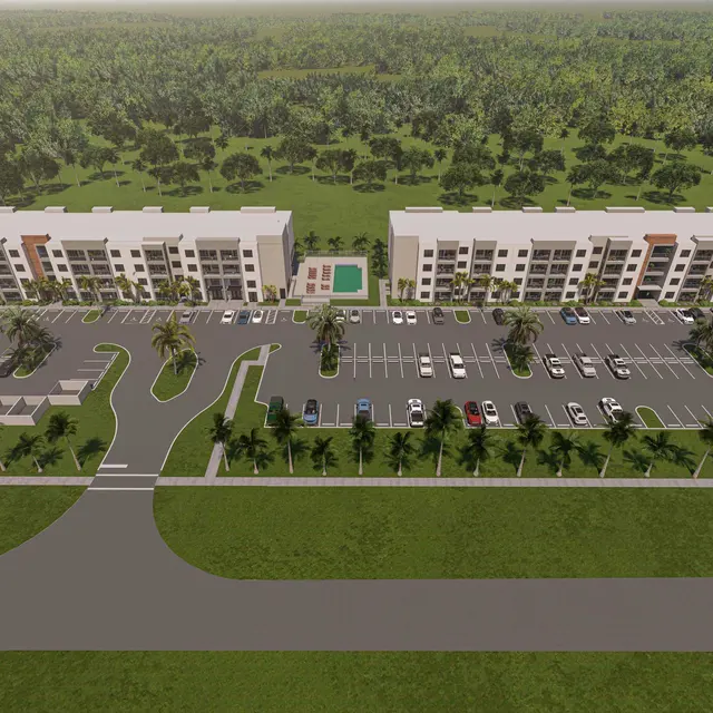 Aerial view of a modern apartment complex with two main buildings, landscaped grounds, and a parking lot.