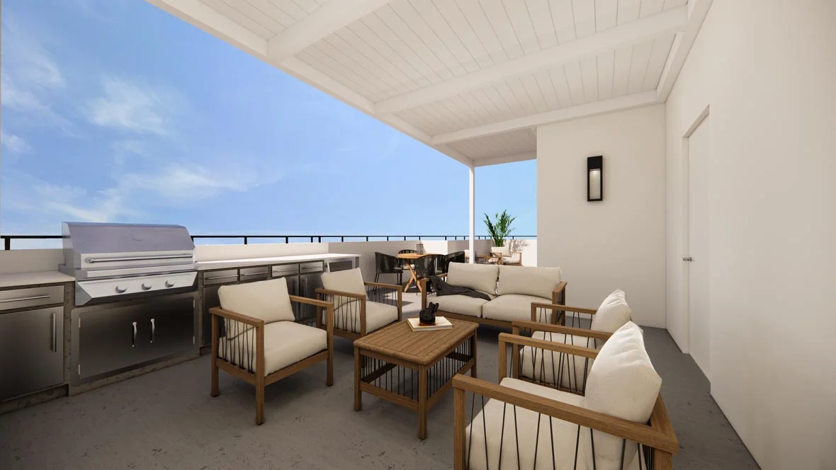 A spacious outdoor living area with comfortable seating, a wooden table, and a barbecue grill under a covered patio.