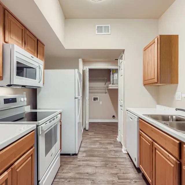 Spacious Modern Kitchen Modern kitchen with wooden cabinets, stainless steel appliances, and white countertops