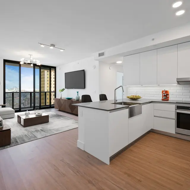 Bright and modern apartment interior featuring a kitchen and living area.