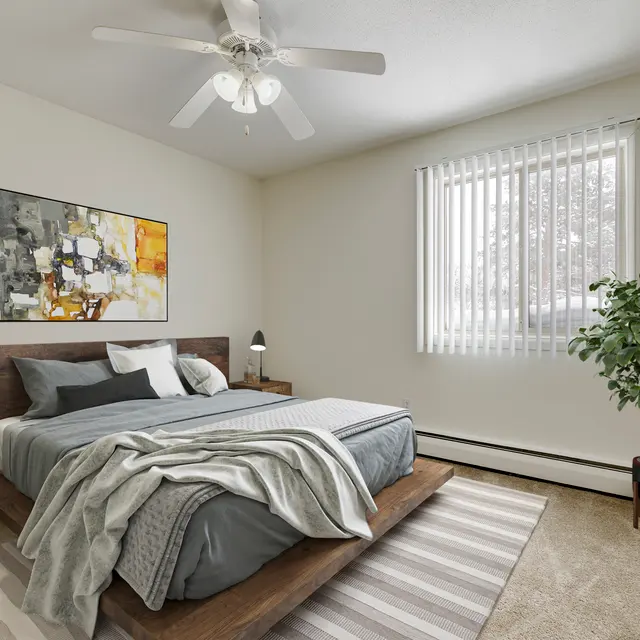 Regency Park Apartments Regency Park - A modern bedroom featuring a wooden bed frame with gray bedding, two nightstands with lamps, and a potted plant. A large abstract painting hangs on the wall, and there is a window with white blinds letting in natural light.