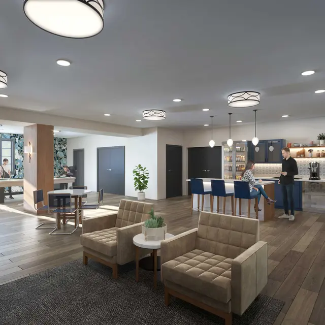 A spacious and modern communal living area featuring comfortable seating, a bar, and social spaces.